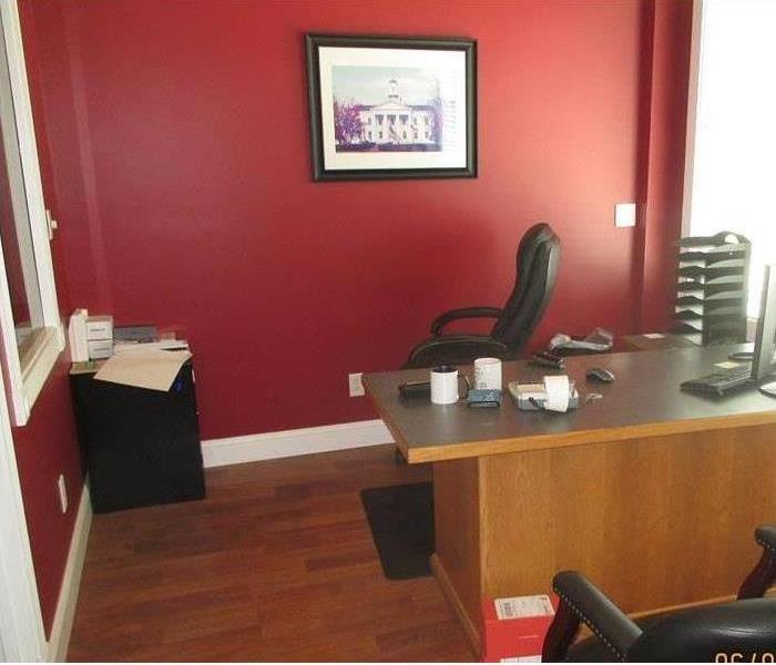 a completely restored office neatly presentable previously damaged by a busted water pipe.