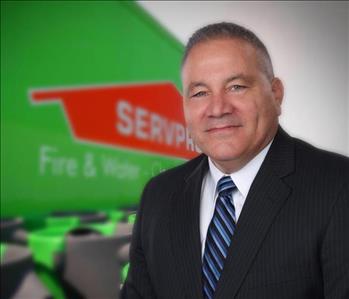 Man in suit in front of a SERVPRO Trailer background