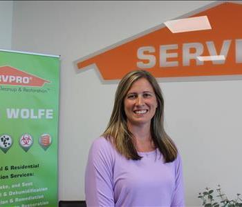 female employee with a SERVPRO themed background