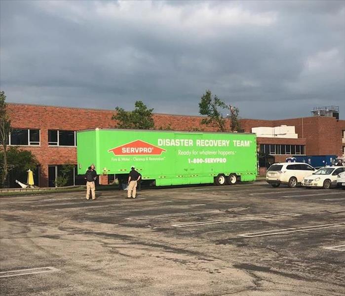 A SERVPRO trailer parked in front of a city municipal building