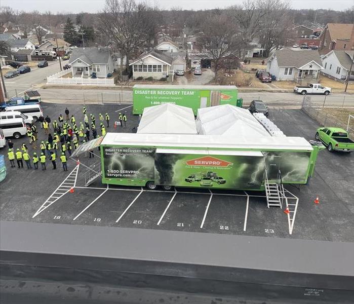 Our mobile command center and SERVPRO equipment trailer parked in a parking lot with several technicians ready to start work