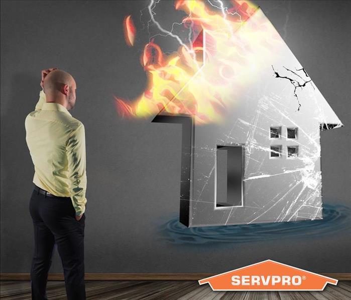man scratching his head looking at a silhouette of a house on fire 